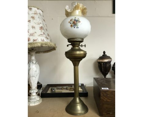 A brass oil lamp with shade.