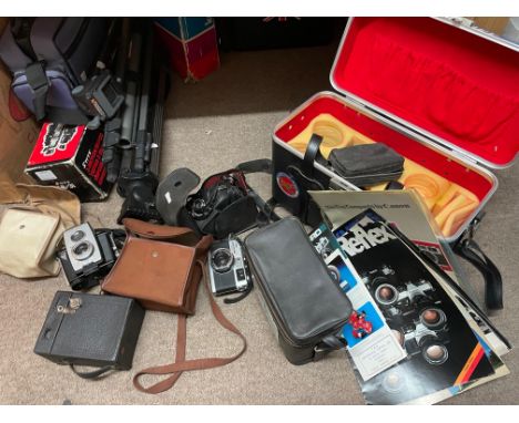 A collection of vintage 35mm camera equipment including two Canon cameras, Olympus lenses, a Ricoh 500ME and other camera equ