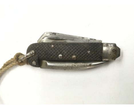 A 1943 dated British army jack knife with original lanyard.