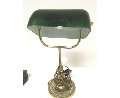 A brass and green coloured glass desk lamp fitted for electric.