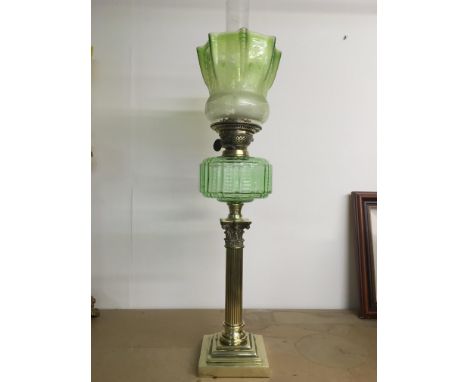 A Victorian green glass Corinthian column oil lamp, approx height 76cm.