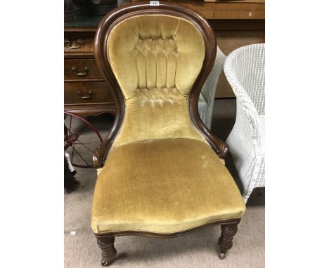A Victorian mahogany spoon back chair with button back on turned legs