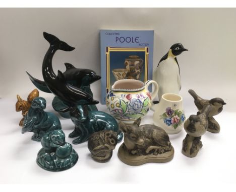 A collection of Poole pottery comprising mainly figures of animals together with a Poole pottery book.