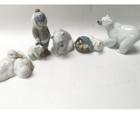 Four small Lladro figures including three Polar Bear themed and one ducklings figurine. Also a Nao small figure group of two 