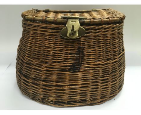 A vintage cane fishing basket with brass fittings.