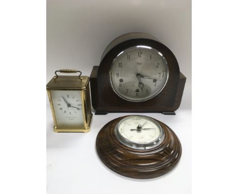An oak cased circular barometer, oak cased mantle clock and a brass cased  carriage clock (3).