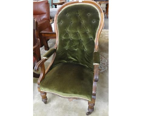 Victorian mahogany button back upholstered fireside open armchair on baluster turned legs and casters.   (B.P. 21% + VAT) 
