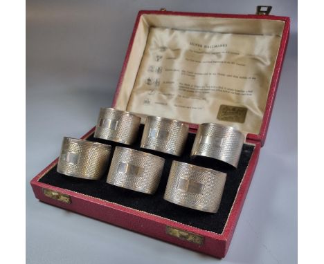 Cased set of six engine turned napkin rings with various hallmarks across the years, Sheffield, Birmingham, Glasgow Edinburgh