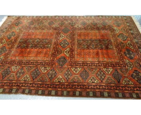 Vintage Middle Eastern red ground carpet with multi geometric panels and foliate decoration. (B.P. 21% + VAT)  Dimensions: 31