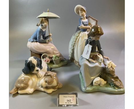 Collection of three Nao Spanish porcelain figures of young girls with animals and parasols, together with a Nao puppy group. 