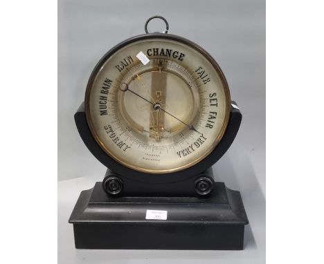 Early 20th Century gilt metal framed aneroid barometer on ebonised stand or base. (B.P. 21% + VAT)  Diameter of the dial is 2