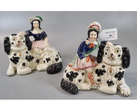 Pair of 19th Century Staffordshire figures sitting on large Spaniel dogs. (2) (B.P. 21% + VAT)  Some minor losses to paintwor