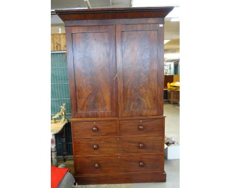 19th century mahogany linen press cupboard, the moulded cornice above two blind panelled doors, the interior revealing three 