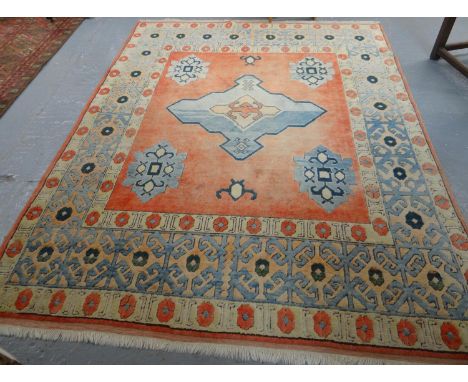 Turkish style salmon ground carpet with central tarantula medallion and foliate designs to the borders. (B.P. 21% + VAT)  Dim