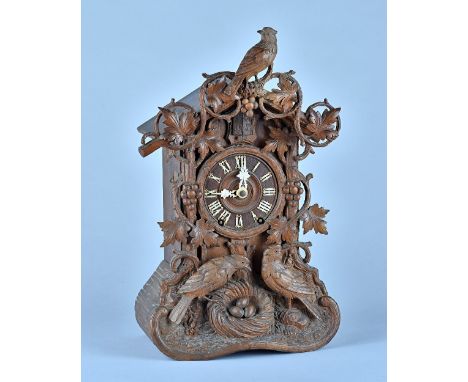 A German carved fruitwood 'Cuckoo' clockBy Beha, Late 19th CenturyWith carved cresting piece, stamped above the movement  BEH