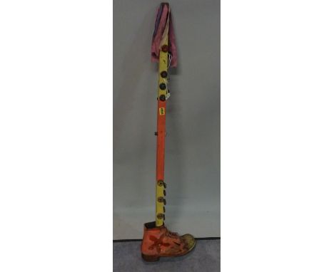 20th century, a morris dancers tipstaff decorated with bottle tops, with a single shoe for the base, 118cm tall. 