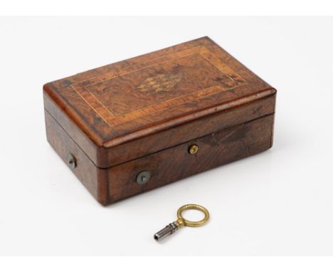 A Swiss walnut and inlaid music box, late 19th century, playing two airs, on a three inch brass roller, 12.5cm wide, (key). (