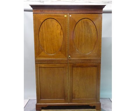 An Edwardian inlaid mahogany twin door wardrobe on bracket feet, 132cm wide x 195cm high.