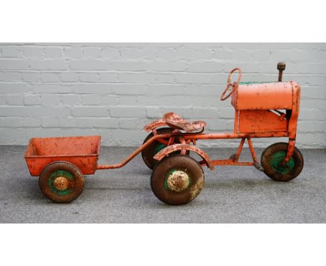 A mid-20th century Triang tin plate pedal tractor and cart, 71cm high with a combined length of 165cm. Condition Report Heavi