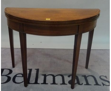 A George III mahogany demi-lune foldover card table on tapering square supports, 97cm wide x 72cm high.  Condition Report The
