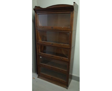 The Lebus bookcase, oak five section glazed bookcase with up and over doors on plinth base, 88cm wide x 177cm high.  Conditio