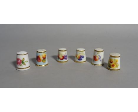 A group of six Royal Worcester thimbles, black printed marks, painted with flowers or fruit, five signed by artists including
