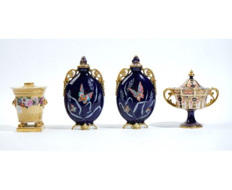 A pair of English porcelain blue-ground two-handled vases and two covers, late 19th century, of flattened ovoid form, each th