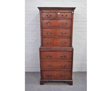 A George III style small mahogany chest on chest with two short over six long graduated drawers, divided by brushing slide on