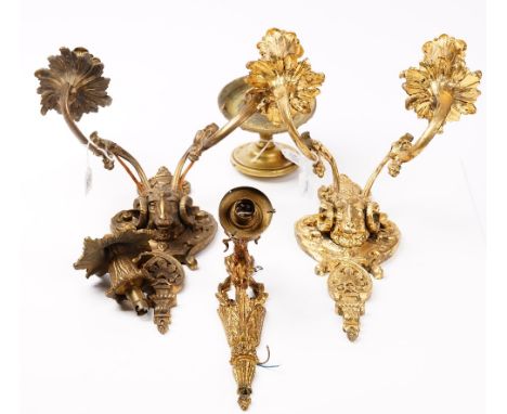 A pair of early 20th century gilt metal twin branch wall lights, decorated with ram's masks, 35cm high, a single branch wall 