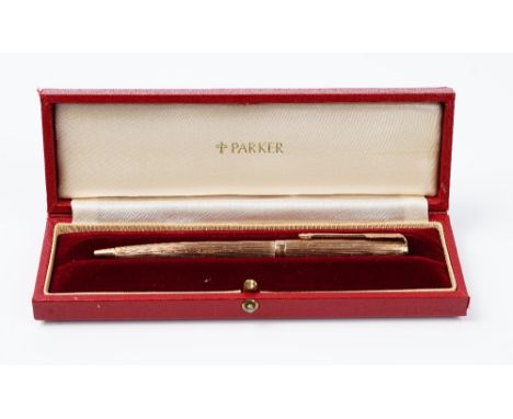 A 9ct gold cased Parker ballpoint pen, hallmarked for London, 1974, with engine turned decoration and vacant rectangular plaq