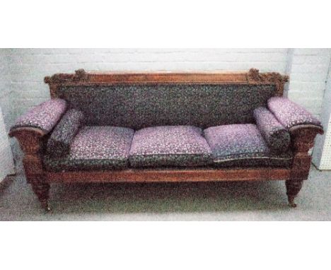 A George IV mahogany framed sofa with leaf carved back and urn arm supports on tapering reeded supports, 212cm wide x 96cm hi