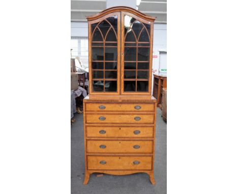 A George III satinwood banded secretaire bookcase chest with a pair of glazed doors over fitted drawer and three further long