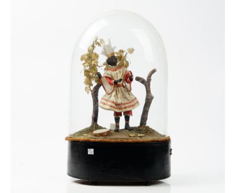 A 19th century automaton of a black musician in a naturalistic landscape, displayed under a glass dome on an ebonised base, h