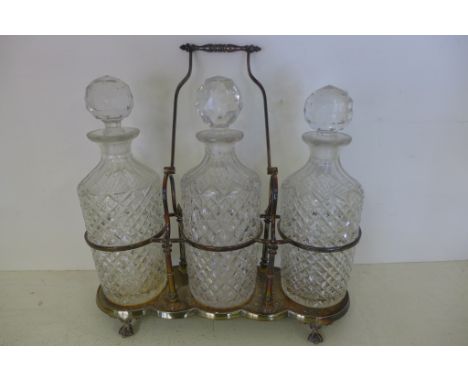 A three decanter plated Tantalus - some usage marks, decanters good
