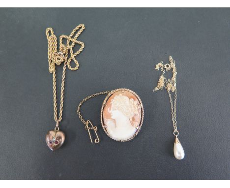 An early 20th century 9ct gold seed pearl and ruby heart-shape pendant - Hallmarked Birmingham - Suspended from a later rope-