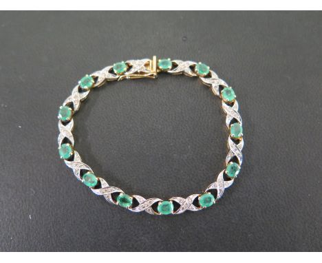 An emerald and diamond panel bracelet - The oval emeralds to the kriss-kross panels set with brilliant-cut diamonds - Stamped