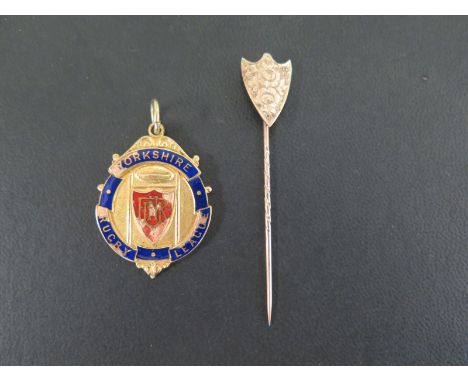 A 9ct gold Yorkshire Rugby League medal - With enamel detail and reverse inscription - Hallmarked Birmingham - Length 4.3cms 