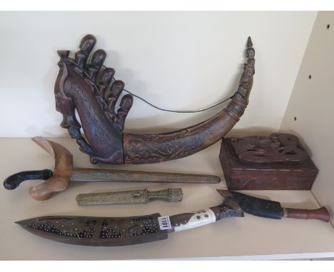 An Indonesian Kris with walnut scabbard, carved medicine boat and assorted Kukri  with carved box
Condition report: Assorted 