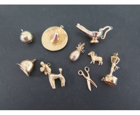 Nine assorted charms - To include a poodle, a lamp post and a pineapple, together with six further charms - All with marks in