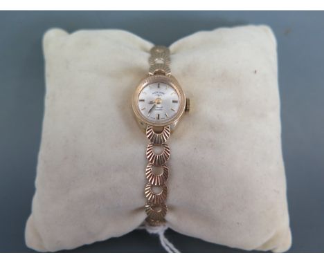 A Ladies 9 ct gold Rotary cocktail watch having metallic dial with applied stick markers and filled pencil hands with shell l