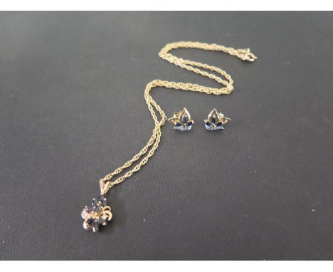 A set of 9ct gold sapphire and diamond jewellery - To include a marquise sapphire and single-cut diamond pendant suspended fr