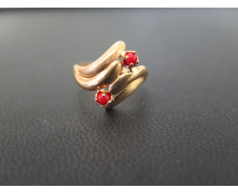 A red-gem bead dress ring - Stamped 750 (18ct) - Ring size N - Weight approx 2.6gms
Condition Report: Good