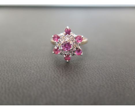 A 9ct gold ruby and diamond cluster ring - Hallmarked London - Ring size N - Weight approx 3.2
Condition Report: Good 