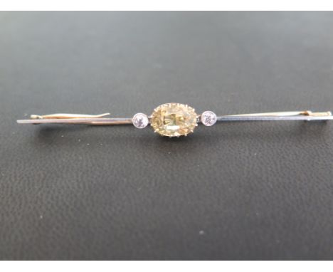 A sapphire and diamond bar brooch - The oval yellow sapphire to the old-cut diamonds and plain bar - Estimated total diamond 