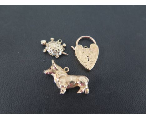 Two 9ct gold charms - To include a dog and a tortoise - Together with a padlock clasp - All with makers mark 'GJLtd' - Hallma