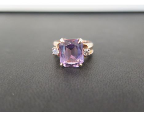 An amethyst and diamond three-stone ring - Tests as higher carat gold - Ring size M - Weight approx 7.4gms
Condition Report: 