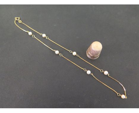 A box-link chain with cultured pearl spacers - Stamped 18Kt - Length 39cms - Weight approx 3.4gms - Together with a thimble -