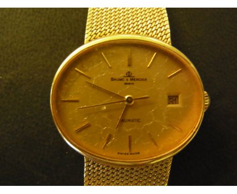 An 18ct Gentlemans Baume & Mercier Baumatic wristwatch - having horizontal oval dial with stick markers and gilt hands with d