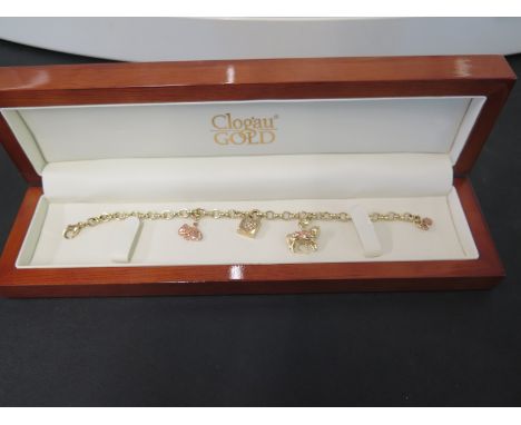 CLOGAU GOLD - A 9ct bracelet - Suspending three charms, one with a diamond-set heart - Hallmarked Birmingham - Length 19.5cms