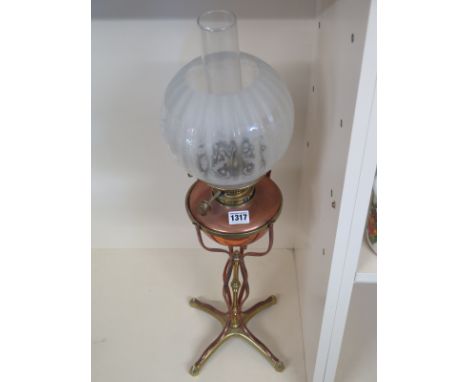 A vintage brass and copper oil lamp, etched glass shade over reservoir on stand, overall height 70cm - small dents to reservo